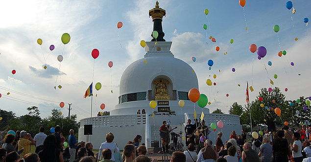 Aufsteigende Luftballons vor buddh. Tempel